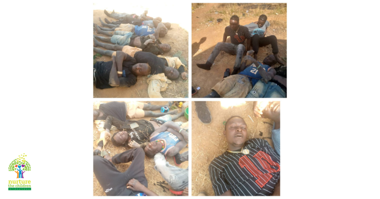 A group of men lie on the ground in outdoor settings, some with eyes closed, appearing injured or unresponsive. The logo "Nurture the Children" is in the lower left corner.